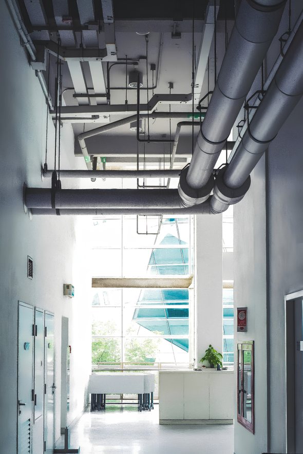 Ductwork and mechanical piping running through a building lobby